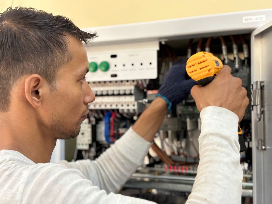 Electrician performing electrical repair work on a residential panel in Boca Raton, FL