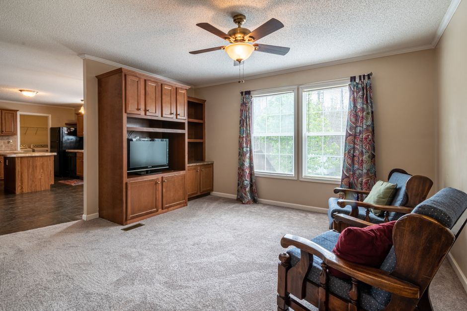 Living room with a ceiling fan installed in a Boca Raton, FL home