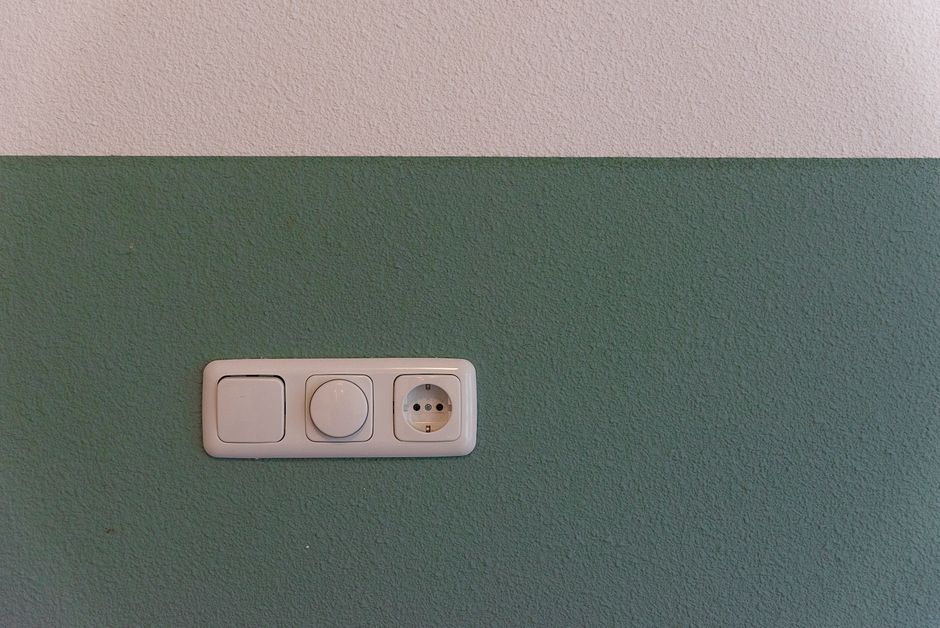 Close-up of a residential light switch on a wall in a Boca Raton, FL home